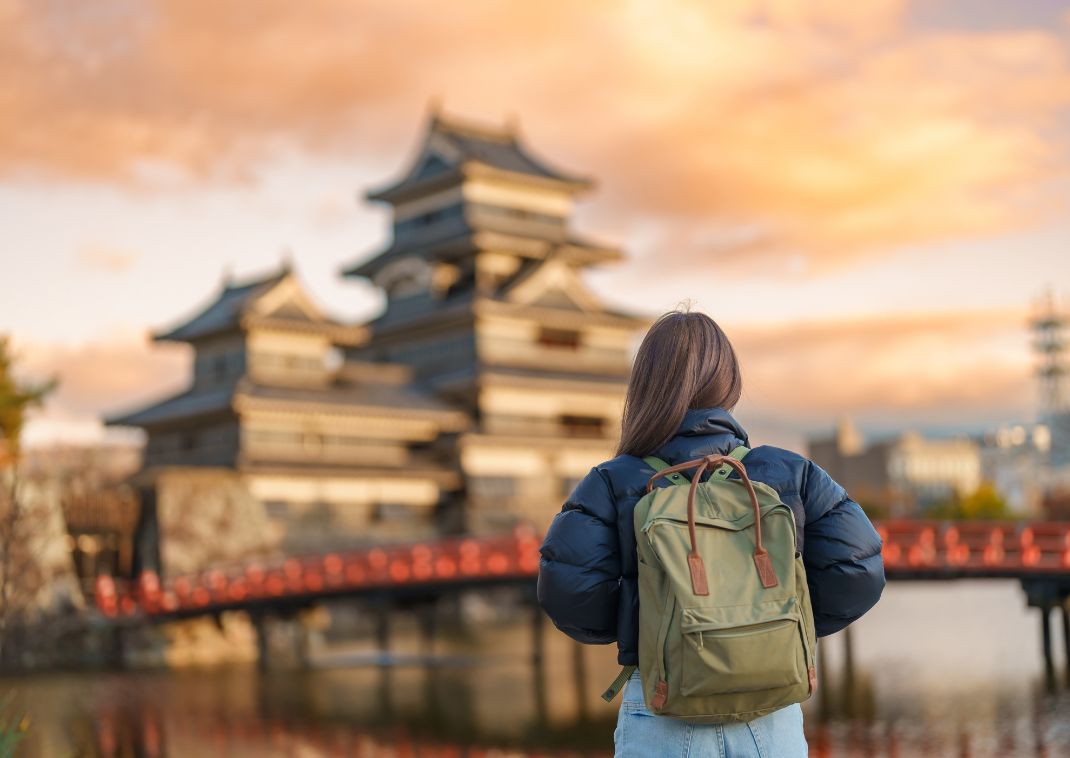 Dame regardant le château de Matsumoto au Japon