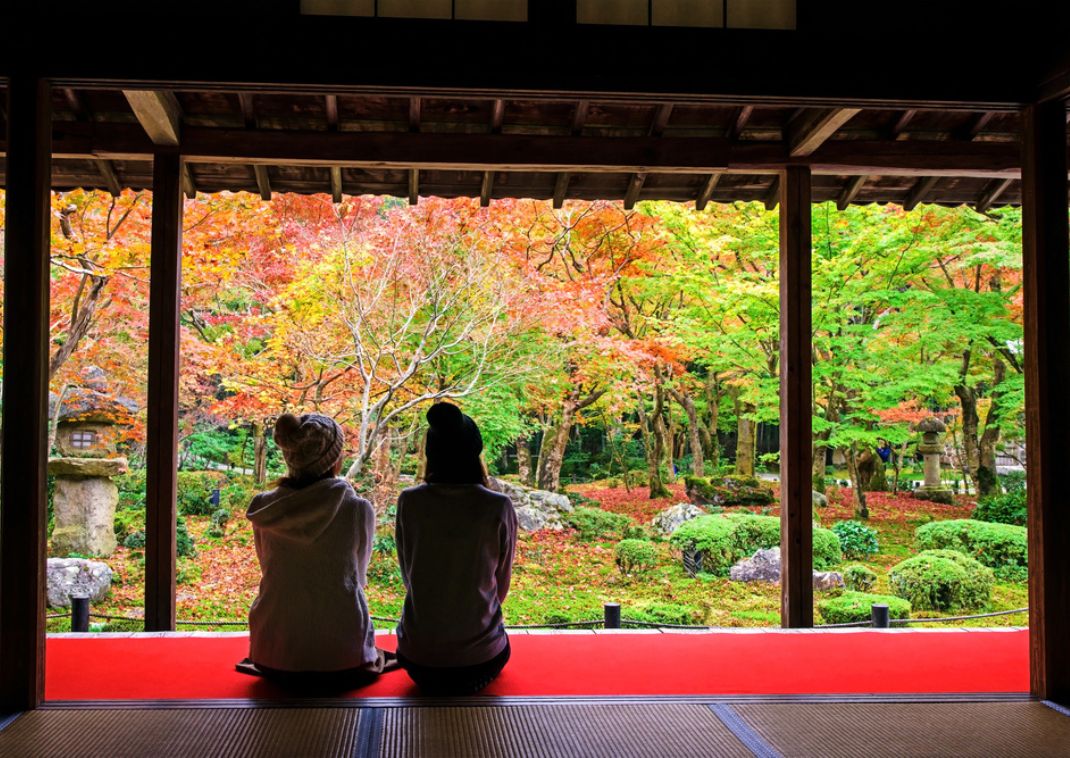 Deux jeunes femmes assises dans le jardin du temple Enkō-ji, Kyoto, Japon