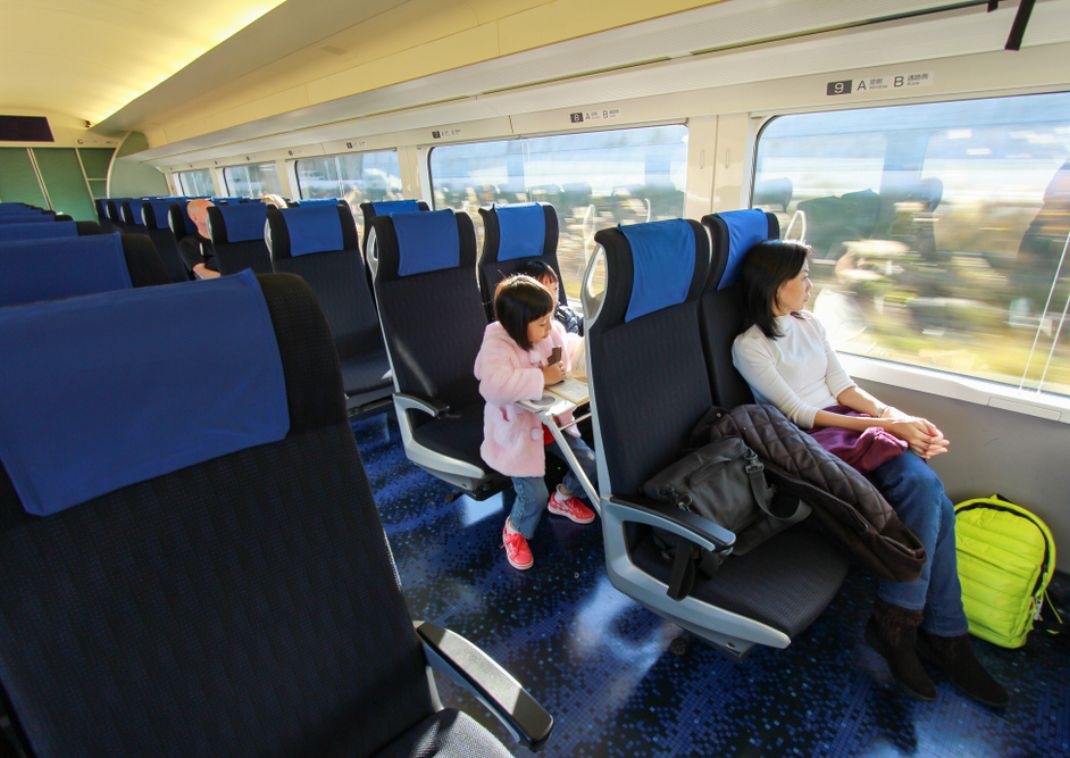 Mother and child on Japanese bullet train looking out of the window