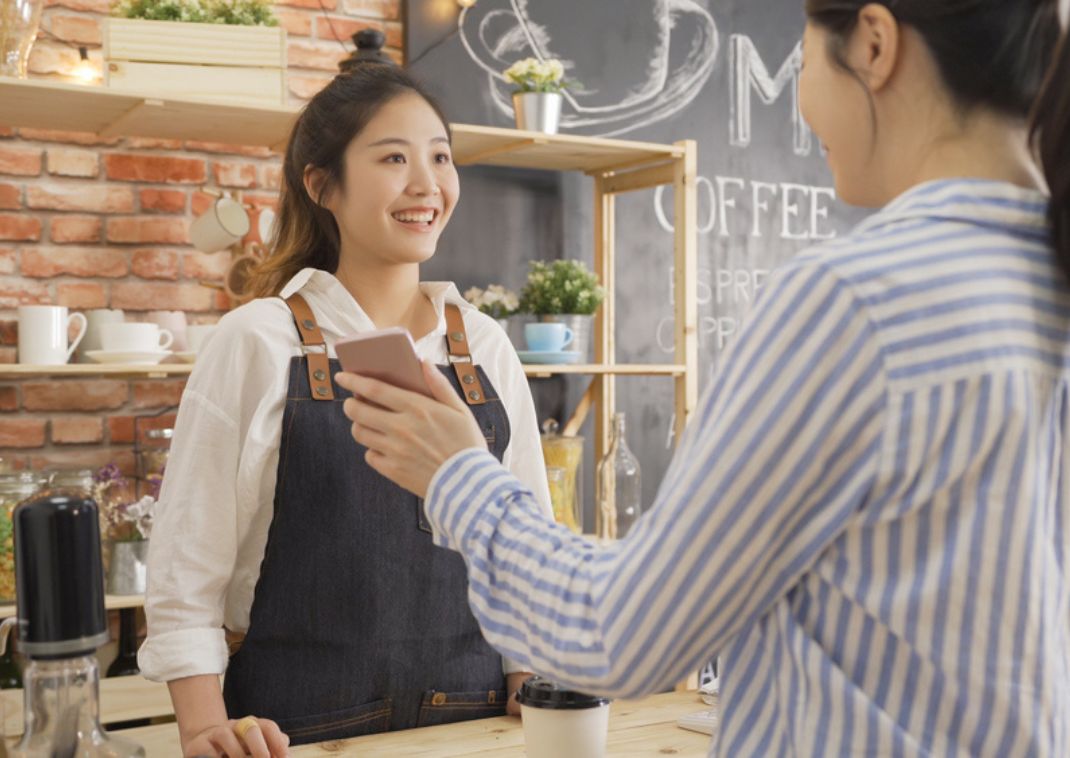 Barista japonaise servant une cliente, Japon
